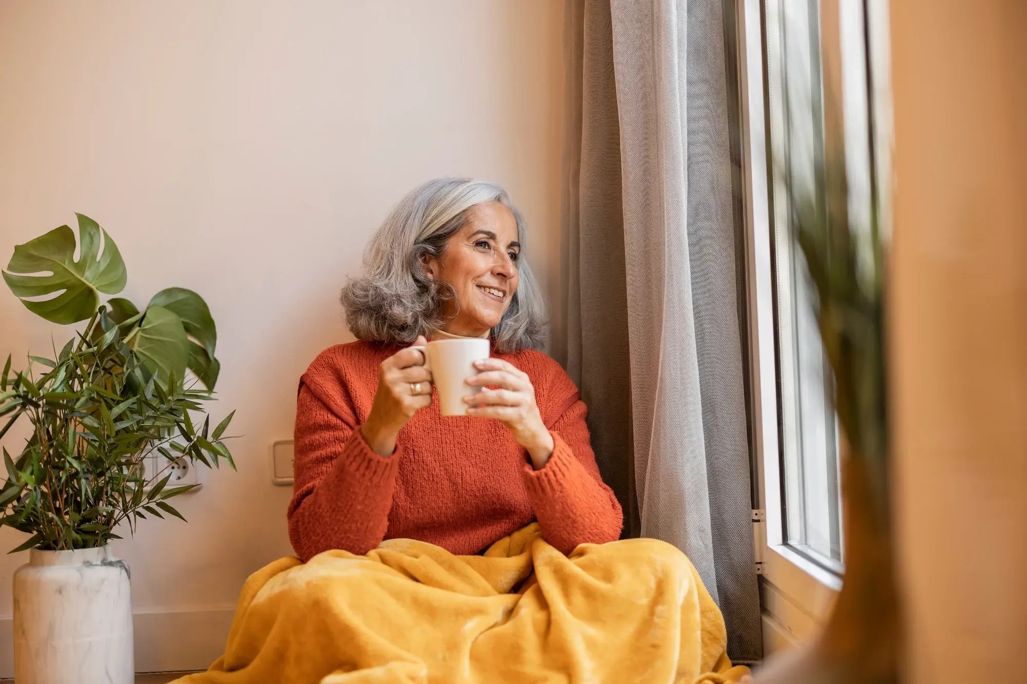 An older adult living independently in a comfortable living room