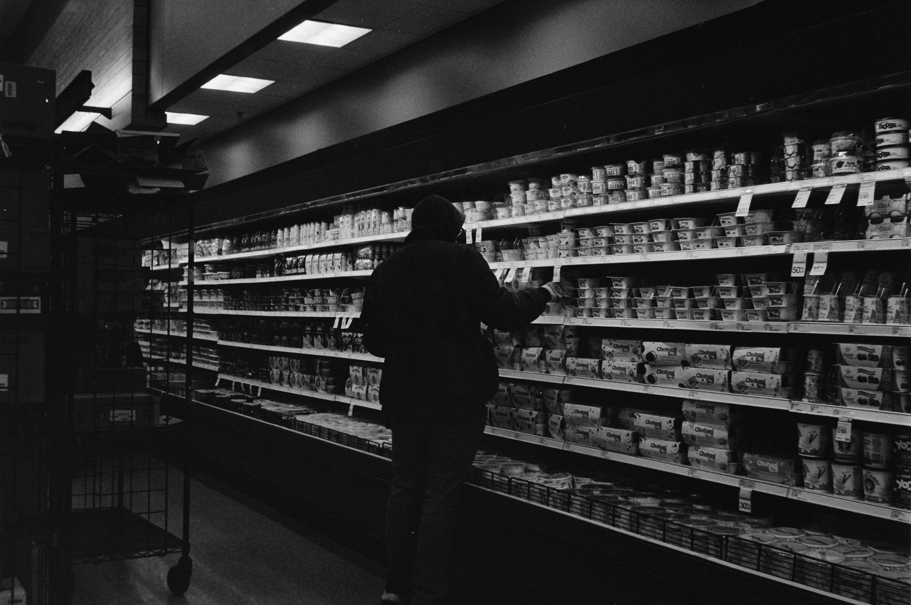 helper navigating a supermarket aisle - grocery shopping assistance helper navigating a supermarket aisle - grocery shopping assistance